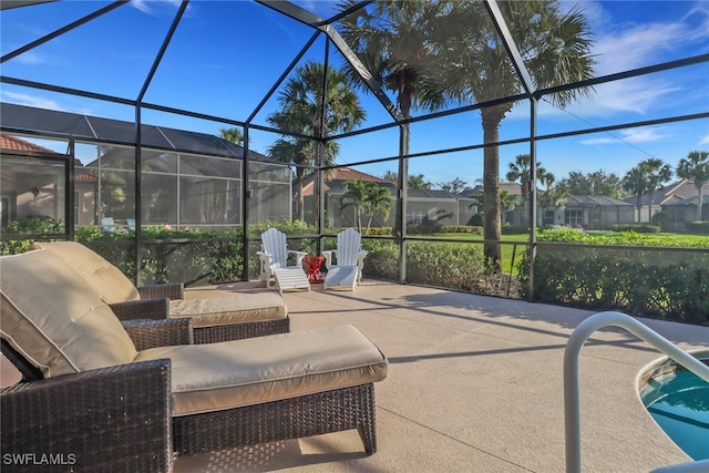 view of patio with glass enclosure, a swimming pool, and a residential view