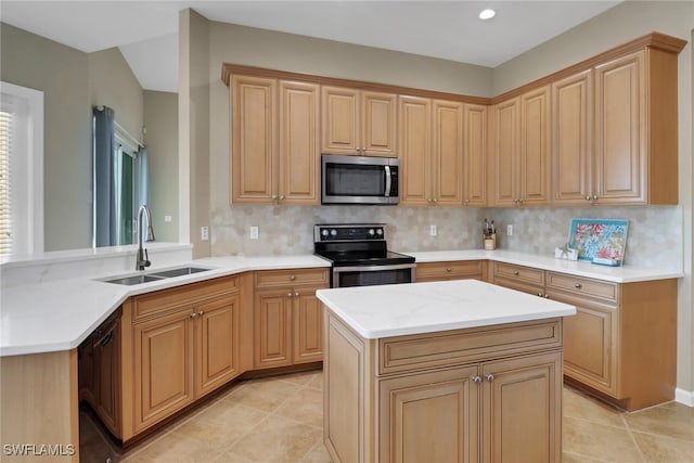 kitchen with a center island, a peninsula, stainless steel appliances, light brown cabinetry, and a sink