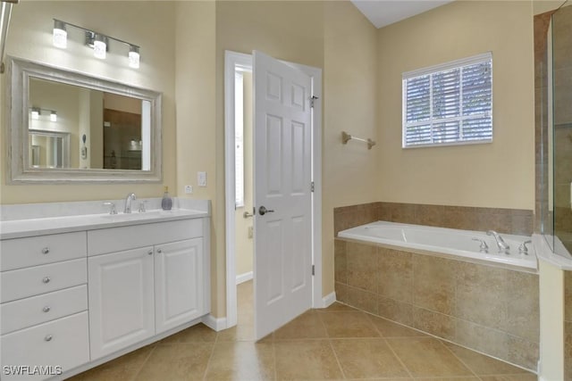 bathroom featuring vanity, tile patterned flooring, and a bath