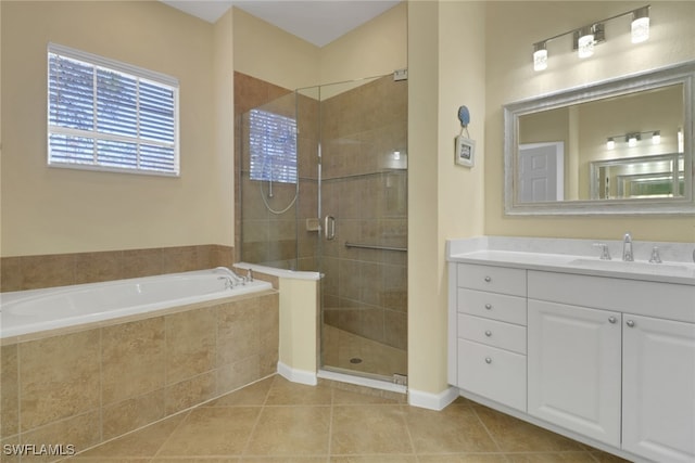 full bath with a stall shower, tile patterned flooring, a garden tub, and vanity