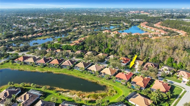 birds eye view of property with a water view and a residential view