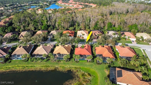 birds eye view of property with a water view and a residential view