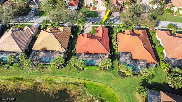 drone / aerial view featuring a residential view and a water view