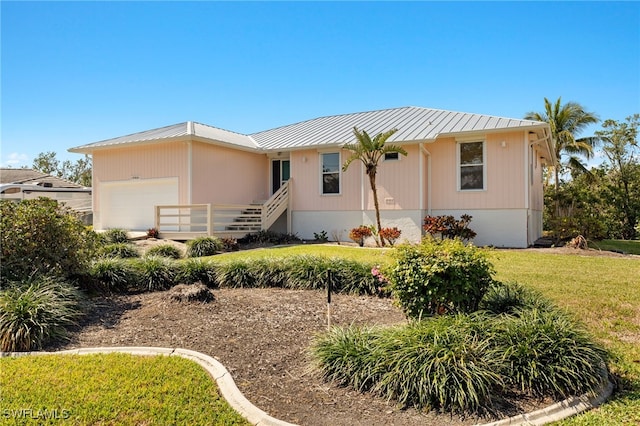 view of front of house with a garage and a front yard