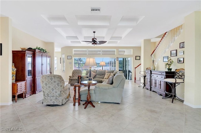 living area featuring beam ceiling, visible vents, coffered ceiling, baseboards, and stairs