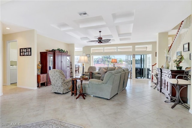 living area featuring washer / dryer, visible vents, coffered ceiling, ceiling fan, and light tile patterned flooring