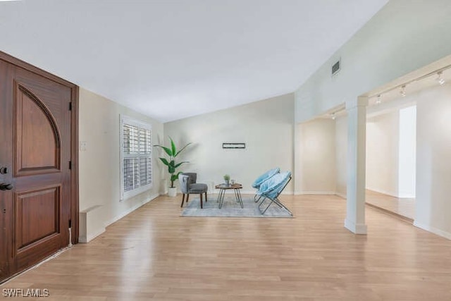 living area featuring track lighting and light wood-type flooring