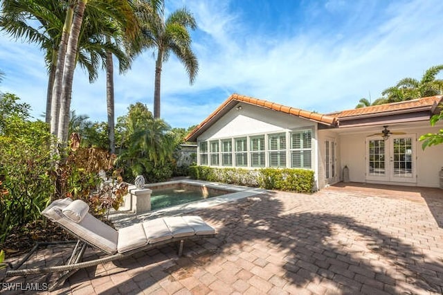 back of property with a patio, french doors, and ceiling fan