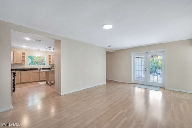 living room with light hardwood / wood-style floors and french doors