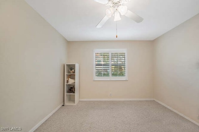 spare room with light carpet and ceiling fan