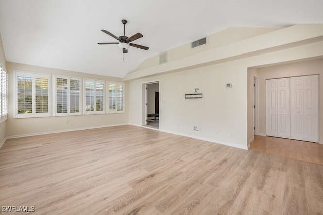 empty room featuring ceiling fan, lofted ceiling, and light wood-type flooring