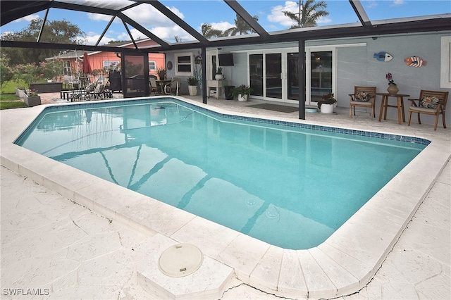 pool with a lanai and a patio