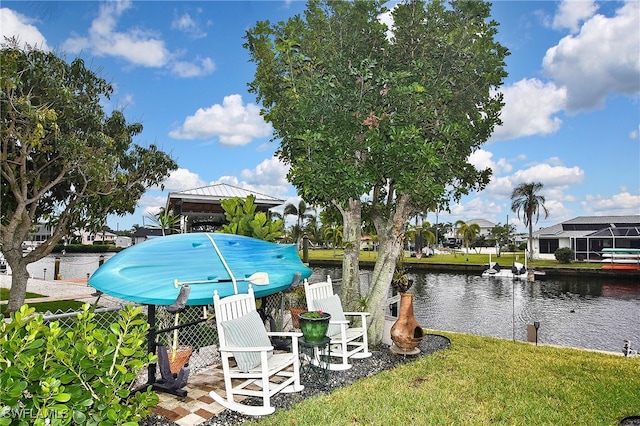 exterior space with a water view and a lawn