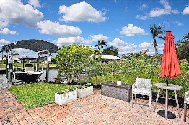 view of patio with a dock and boat lift