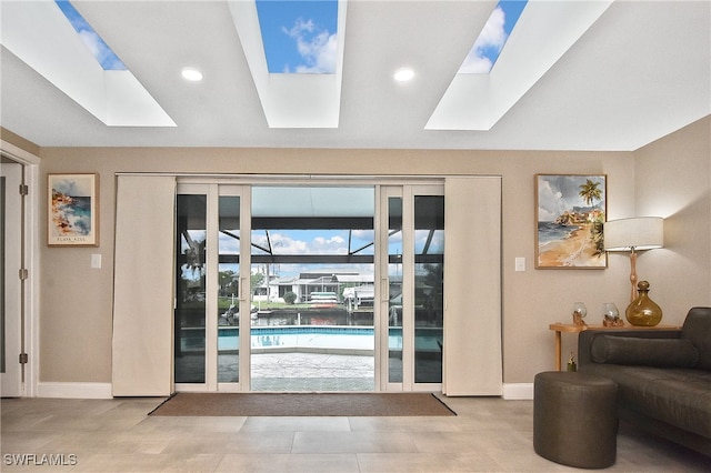 doorway to outside featuring recessed lighting, a skylight, and baseboards