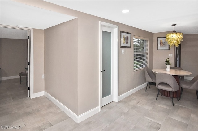 dining room with recessed lighting, baseboards, and a chandelier