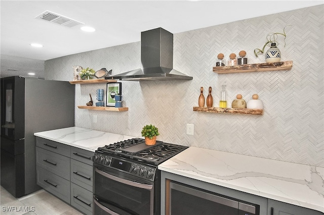 kitchen featuring visible vents, gray cabinets, appliances with stainless steel finishes, wall chimney exhaust hood, and open shelves