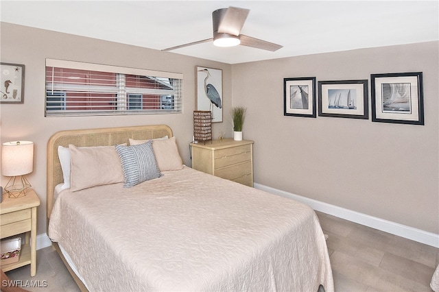 bedroom featuring wood finished floors, baseboards, and ceiling fan