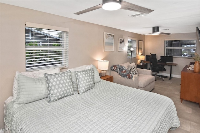 bedroom with baseboards, visible vents, and ceiling fan