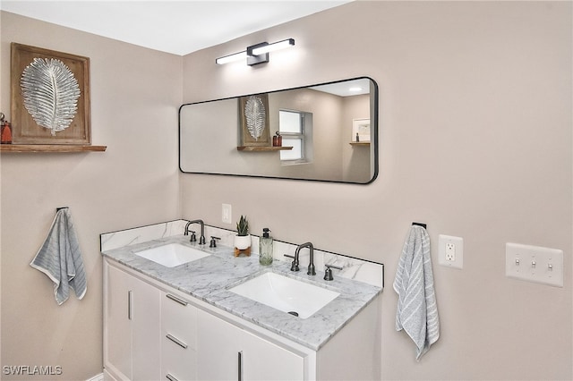 bathroom featuring double vanity, baseboards, and a sink