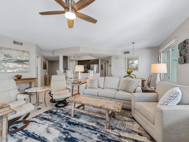 carpeted living room with ceiling fan