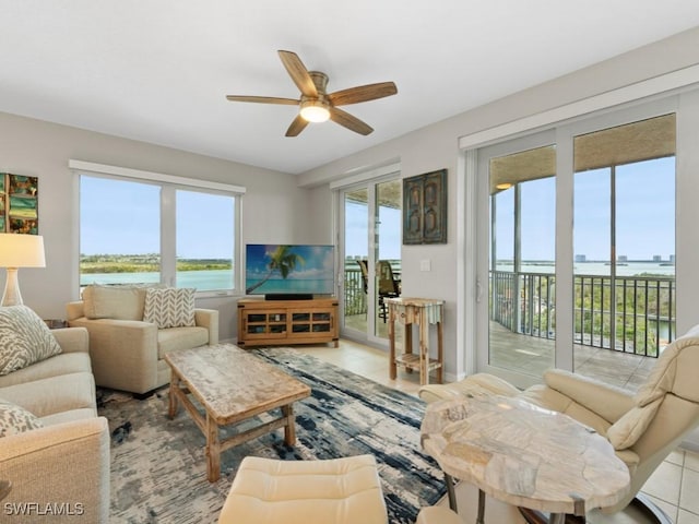 tiled living room with ceiling fan and a wealth of natural light