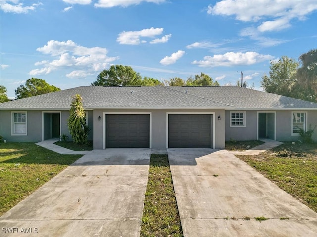 ranch-style home with a garage and a front lawn