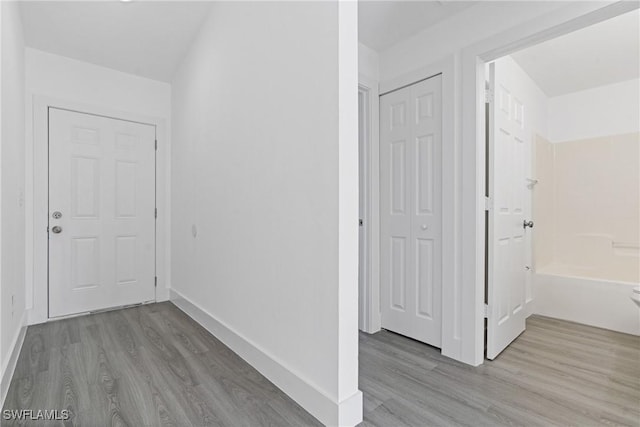 hall with light hardwood / wood-style floors