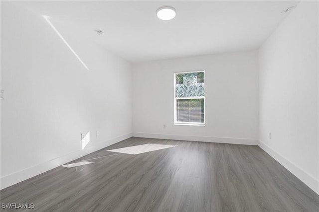 spare room with dark hardwood / wood-style floors