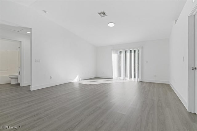 empty room with light hardwood / wood-style flooring