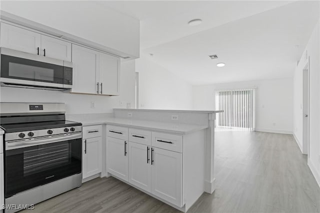 kitchen with appliances with stainless steel finishes, kitchen peninsula, light hardwood / wood-style floors, and white cabinets