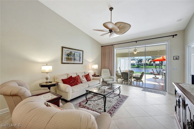 living room featuring a water view, ceiling fan, vaulted ceiling, and light tile patterned floors