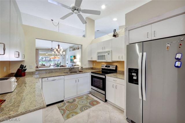 kitchen featuring appliances with stainless steel finishes, decorative light fixtures, sink, and white cabinets