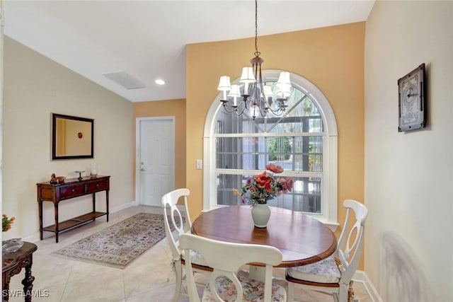 dining room with light tile patterned flooring and a notable chandelier