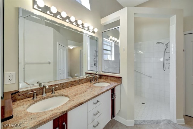 bathroom with vanity, tiled shower, tile patterned floors, and toilet