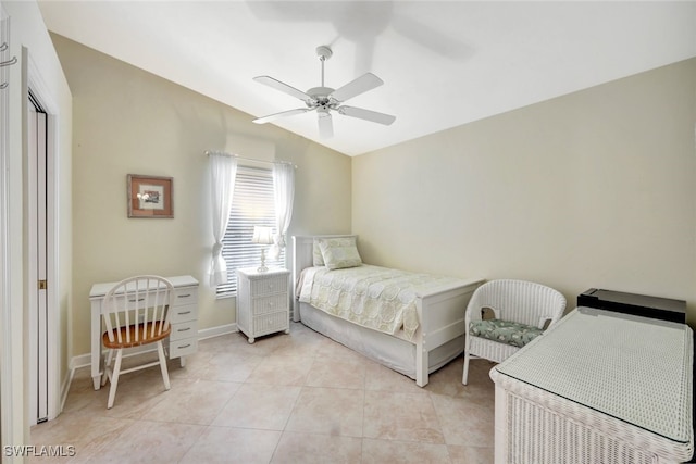 tiled bedroom featuring ceiling fan