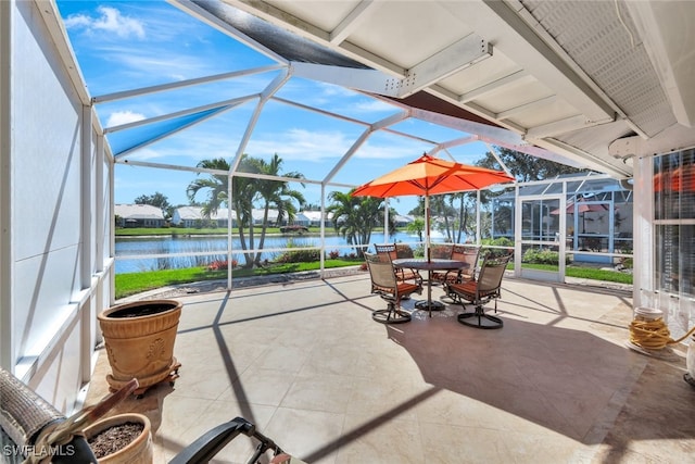 view of patio with a water view and glass enclosure