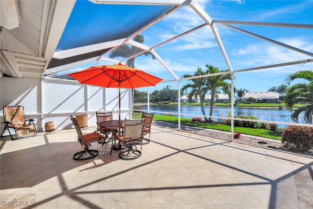 view of patio / terrace featuring a water view and glass enclosure