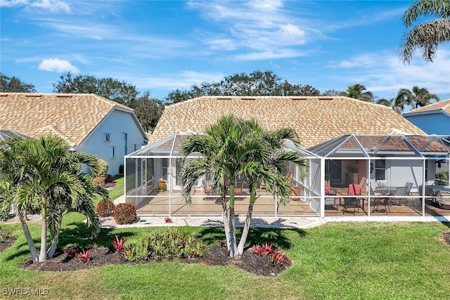 view of front of property with a lanai, a patio area, and a front yard