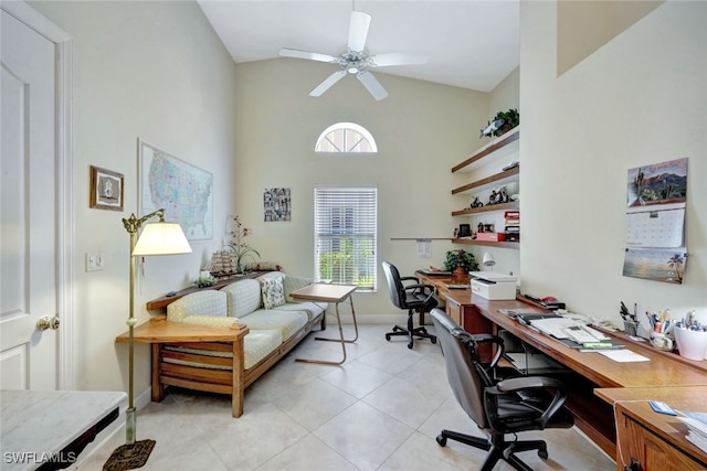 home office featuring a towering ceiling, light tile patterned floors, and ceiling fan