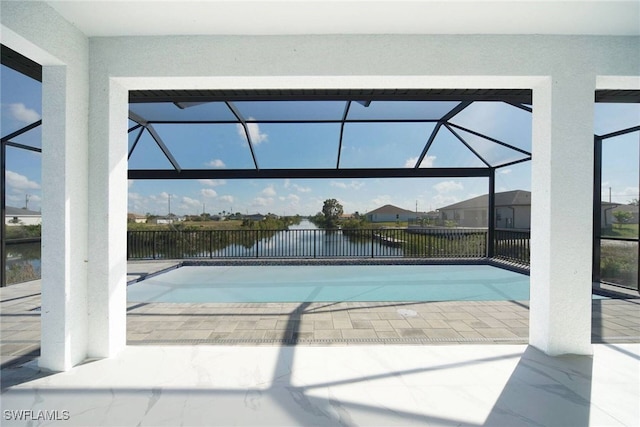 view of pool with a lanai, a patio, and a water view