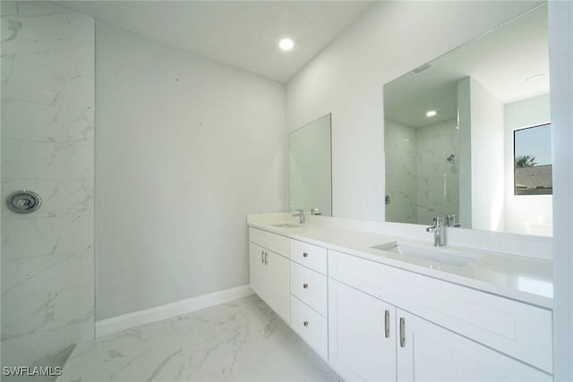 bathroom with vanity and a tile shower