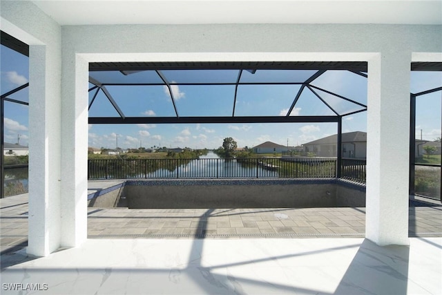 view of pool with a water view, a patio, and a lanai