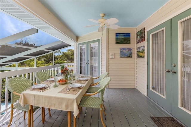 10800 Habitat Cir, Bokeelia, FL 33922 - wooden deck with french doors, a ceiling fan, and outdoor dining area