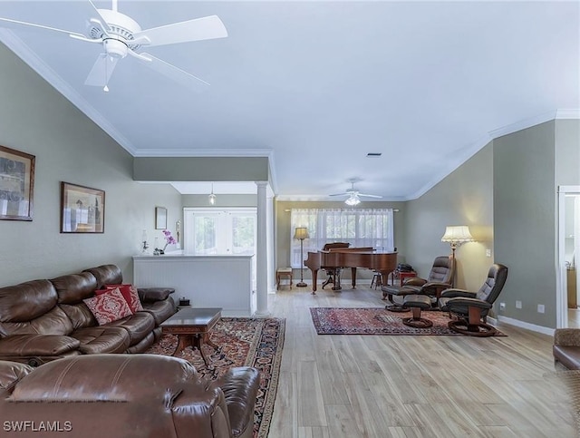 10800 Habitat Cir, Bokeelia, FL 33922 - living room featuring a ceiling fan, wood finished floors, crown molding, baseboards, and decorative columns