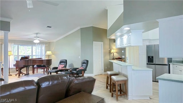 10800 Habitat Cir, Bokeelia, FL 33922 - living area with ceiling fan, ornamental molding, baseboards, lofted ceiling, and decorative columns