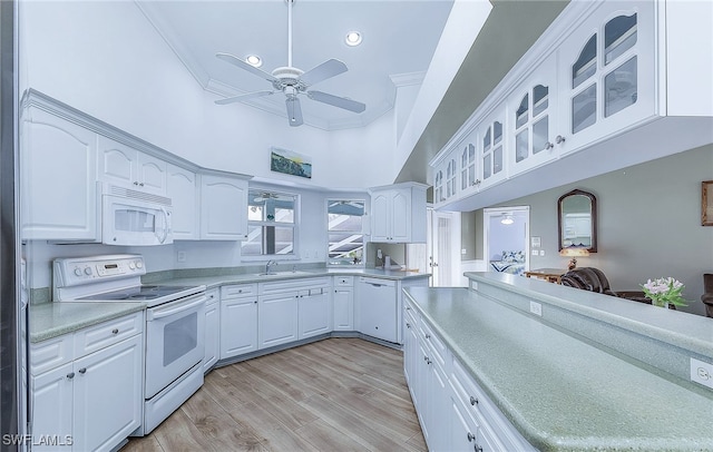 10800 Habitat Cir, Bokeelia, FL 33922 - kitchen with white appliances, ceiling fan, a sink, glass insert cabinets, and light countertops