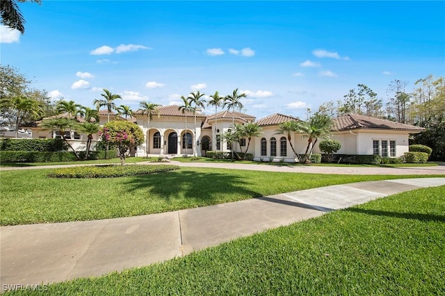 6511 Highcroft Dr, Naples, FL 34119 - mediterranean / spanish home with stucco siding, a front lawn, and a tile roof