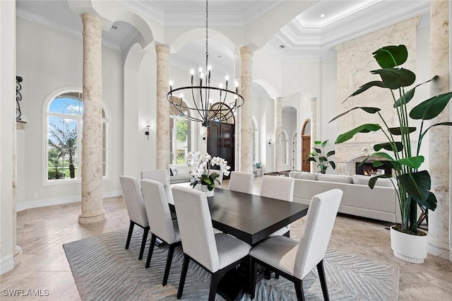 6511 Highcroft Dr, Naples, FL 34119 - dining space with decorative columns, ornamental molding, a chandelier, a high ceiling, and baseboards