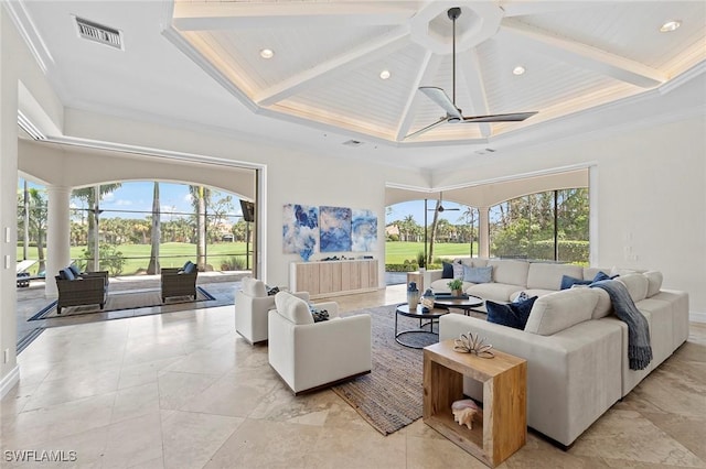 living area with a high ceiling, visible vents, and a wealth of natural light